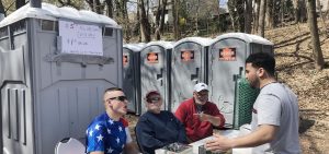 A psrty-goer approached the porta-potties on Fetterman Avenue. 