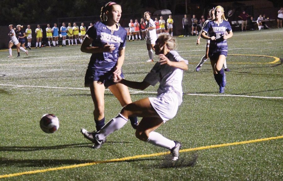 Midfielder Paige Harris is seen striking a ball towards the goal against Shepard 
University. The sophomore set a new season high in minutes recently with 
46 minutes.  
