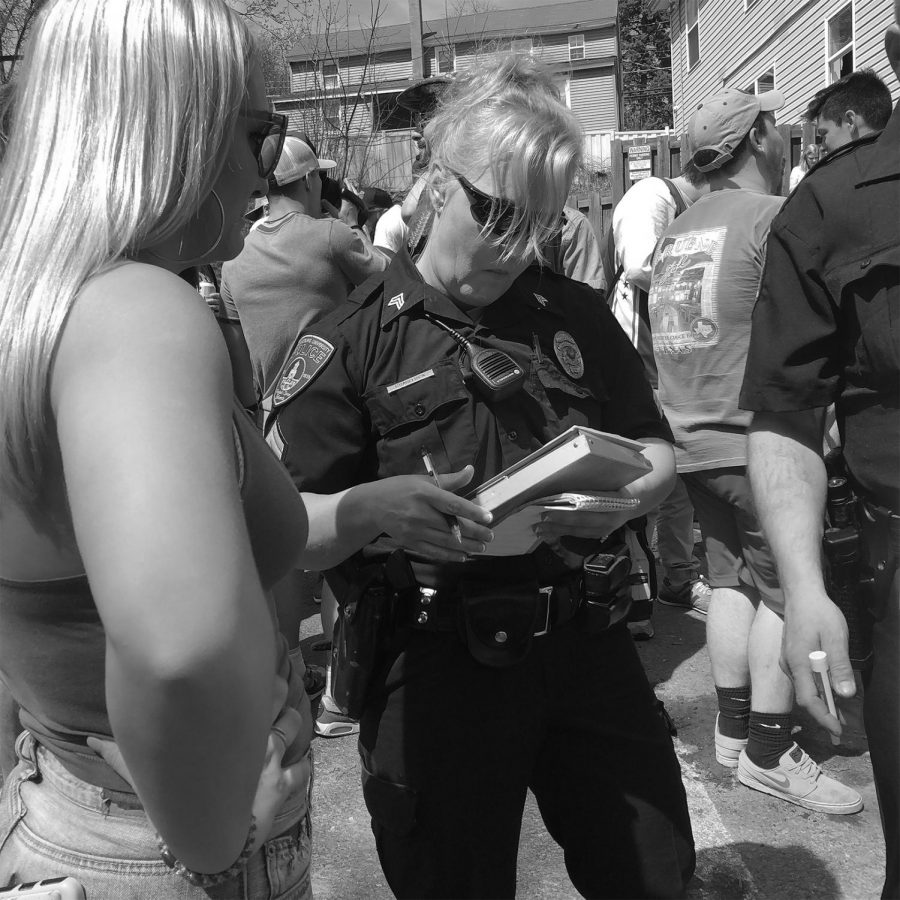A student receiving a citation at last years Block Party from a BU police officer.