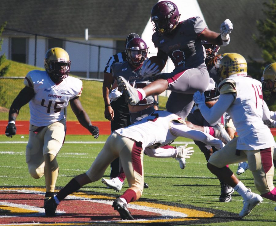 Redshirt junior running back Nyfeast West (pictured above) hurdles the Kutztown defender in the Huskies last game against the Golden Bears this past Saturday.