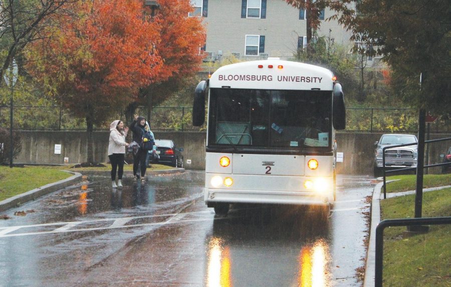 A university bus makes a scheduled stop at the Honeysuckle Apartments Wednesday afternoon.