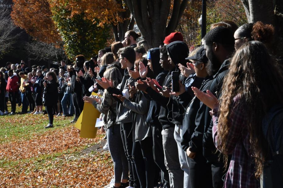 A group of student protestors gather on the quad.
