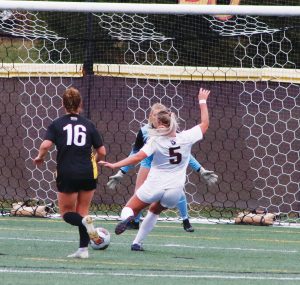 Junior Lauren Hoelke rips in the opening goal in the Huskies 4-0 second round win.