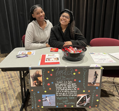Members of Impact, Adriana Glasgow (left) and Scripture House (right), advertised their club at the club fair hosted in Kehr Union Ballroom. Photo by Novalea Verno. 
