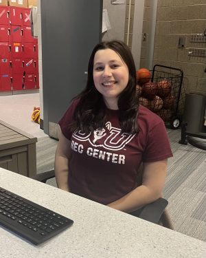 Maya Berger, junior Biology major, working her shift with a smile. Photo by Carly Busfield.