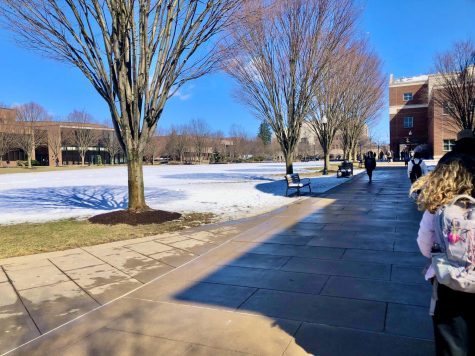 Students walk along sidewalks mid-afternoon after some of the snow has melted. Photo by Caleb Brown. 