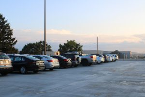 A full tri-level parking lot with many students and faculty parked.