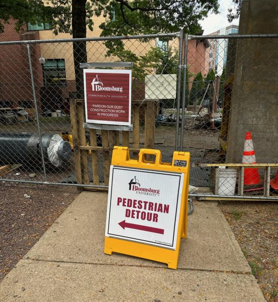 Behind the yellow Pedestrian Detour sign, is just one example of the many construction areas on campus. 