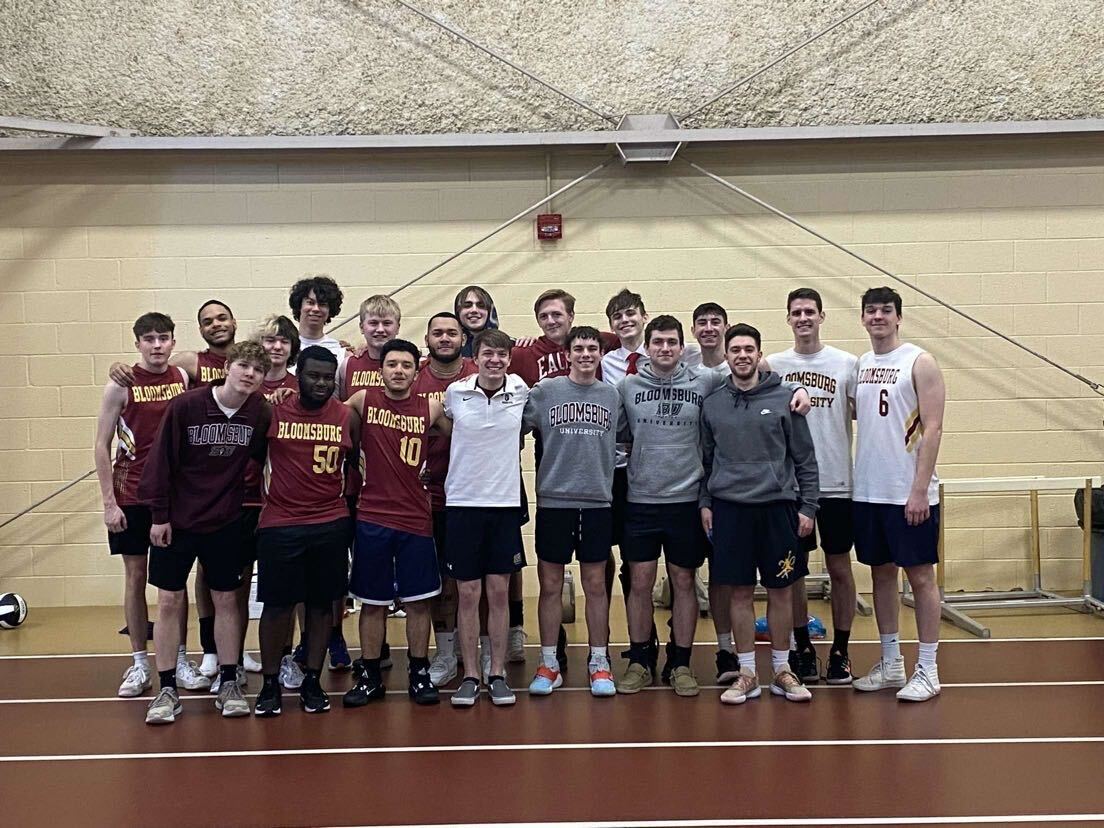 Mens Volleyball Poses For A Picture. Photo via Alex Bartman. 