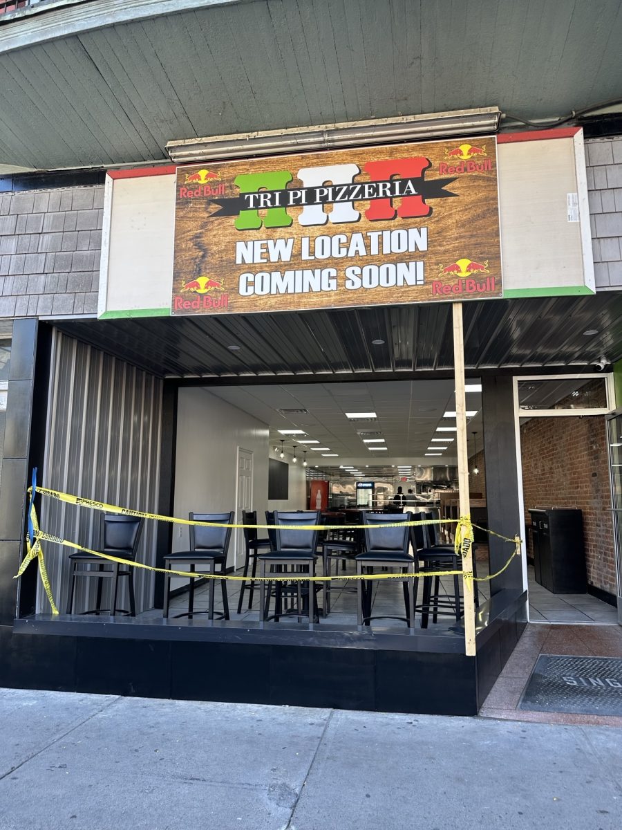 Caution tape covers the storefront of the new and improved Tri Pi Pizzeria. 