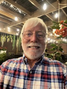 Dr. Michael Martin smiling, relative to his major excitement to move to Poland. 