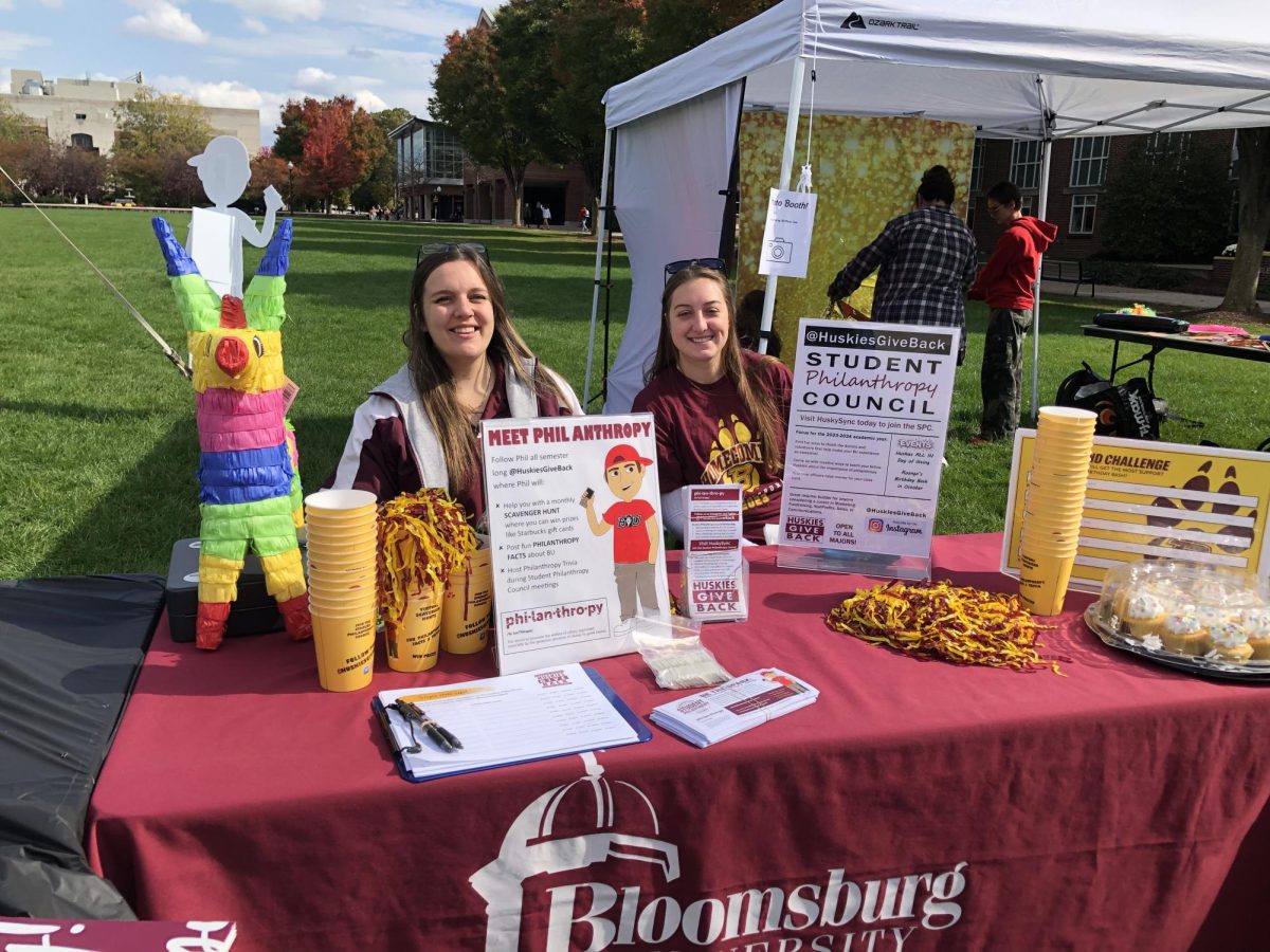 Kailey Morris and Jessica Miscioscia of student philanthropy and at their booth at Roongos birthday celebration.