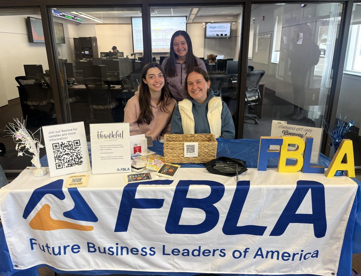 Julianne Emberger (left), Amanda Kaczmarczyk (middle back), and Natalie Miller (right) hosting a table to promote FBLA in Sutliff on Thursday.