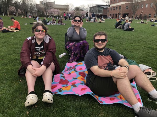 Maxwell Firth, Kyla Korpics, and Danielle Palma ready on the quad with eye protection. 