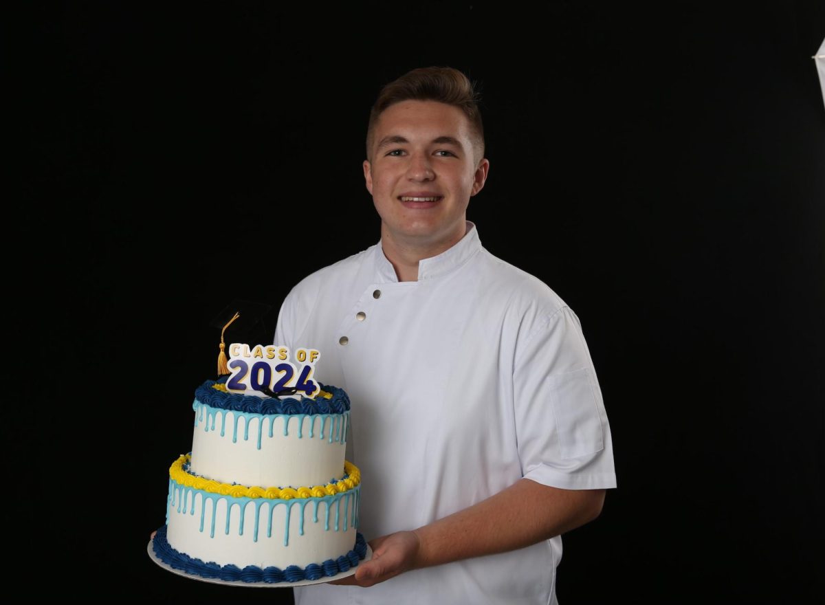 Chaz Kaszuba holding a cake. Photo submitted by Chaz Kaszuba.